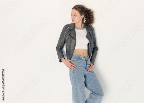 фотографія a woman dressed in accordance with fashion trends, in a leather jacket and a whi