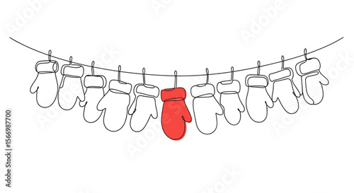 Red mitten hanging among white mittens on a clothesline  