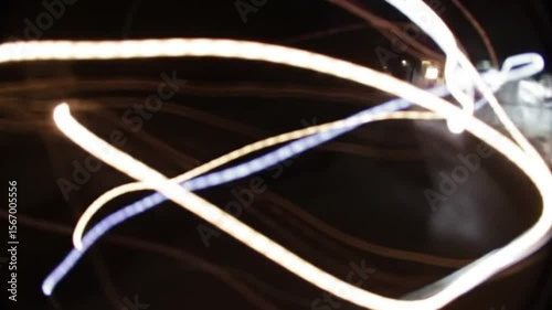 Abstract Light Trails Streaking Against Dark Background Reflecting Night City Lights