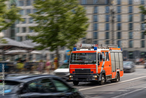 Fire truck in motion. Emergency vehicle on street. Dynamic city scene photo
