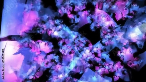 Abstract digital animation of neon purple and blue shapes exploding on black background