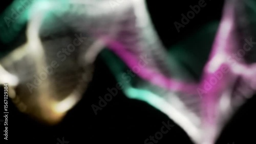 Abstract colorful light trails flowing and moving on a black background