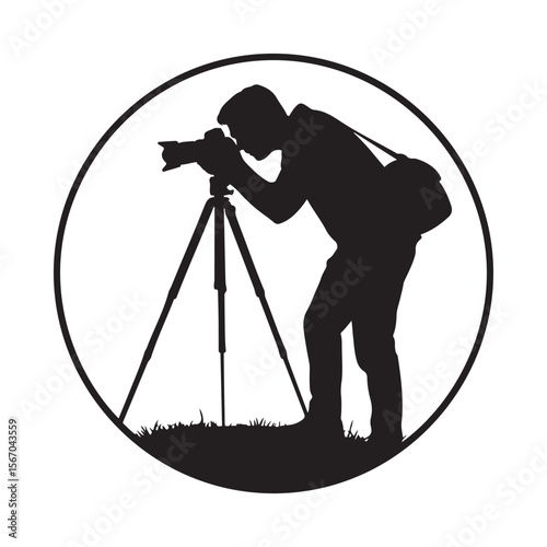 Silhouette of a photographer using a tripod and camera framed within a circle with grass at the bottom