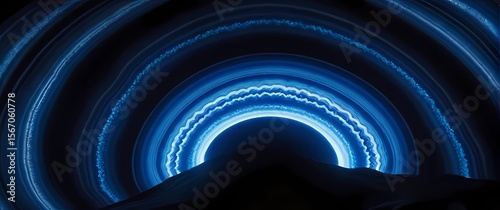 Smooth polished agate stone with swirling bright blue and white concentric patterns
