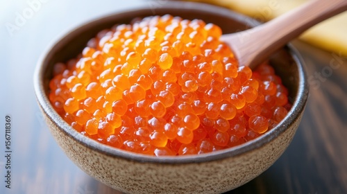 Delicious salmon roe ikura caviar in bowl with wooden spoon gourmet food photography