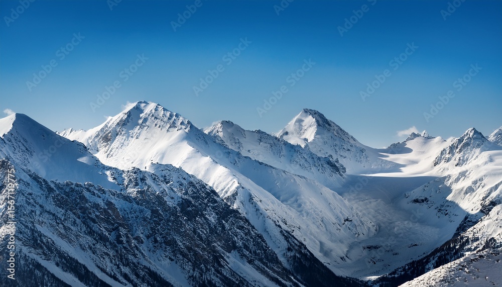 Obraz premium vast winter mountain landscape under clear blue sky with snow covered peaks