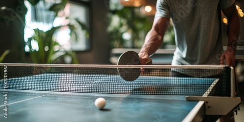 Man Playing Ping Pong Under Sport Banner