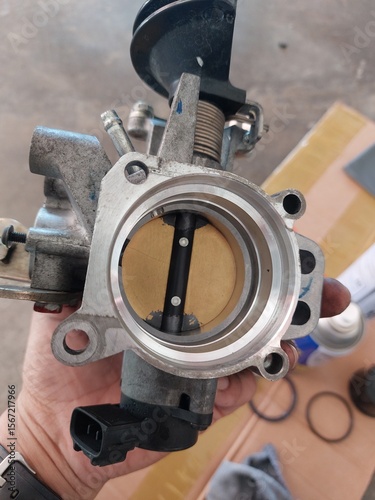 Car engine repair showing throttle body cleaning, sensor inspection, and spark plug maintenance during regular vehicle servicing
