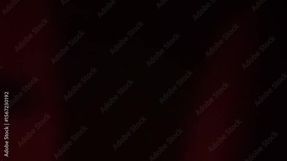 Silhouette of a woman emerges in shifting red and dark light pattern