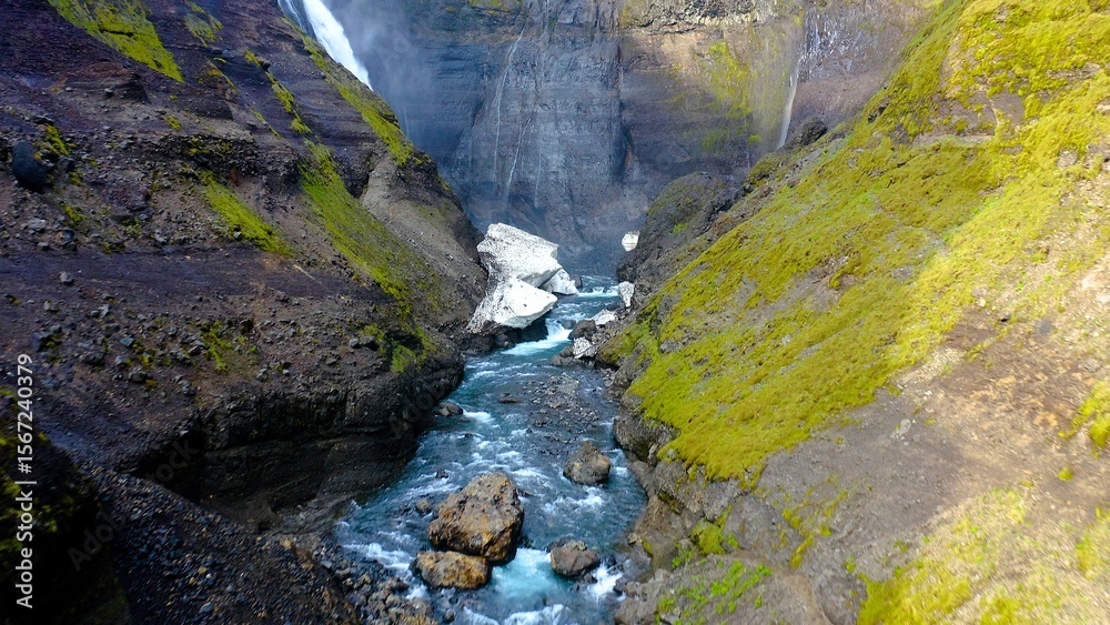 Obraz premium Aerial view of the spectacular Grannifoss waterfall and Fossaa River is a waterfall situated in southern Iceland. The waterfall drops from a height of 122 meters.