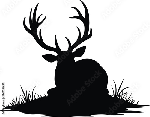 Majestic deer silhouette resting in grassland