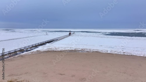 Lighthouse frozen Lake Michigan drone view