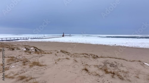 Lighthouse frozen Lake Michigan drone view