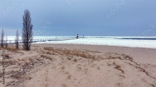 Lighthouse frozen Lake Michigan drone view