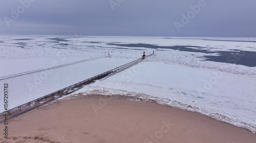 Lighthouse frozen Lake Michigan drone view