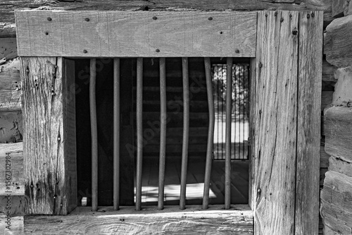 Fototapeta Black and white view through a window of the historical Snodgrass cabin in Chick