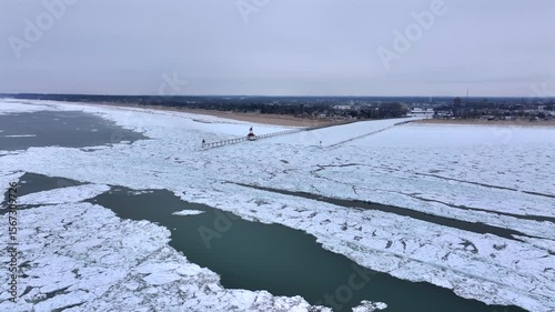 Lighthouse frozen Lake Michigan drone view