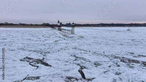 Lighthouse frozen Lake Michigan drone view