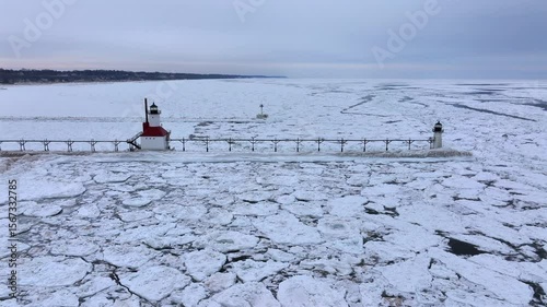 Lighthouse frozen Lake Michigan drone view