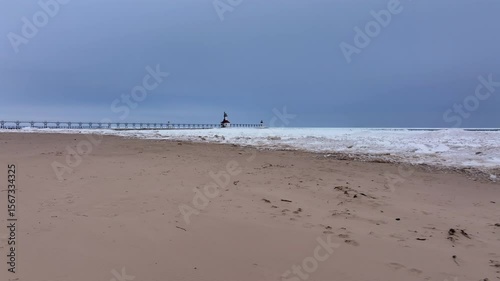 Lighthouse frozen Lake Michigan drone view