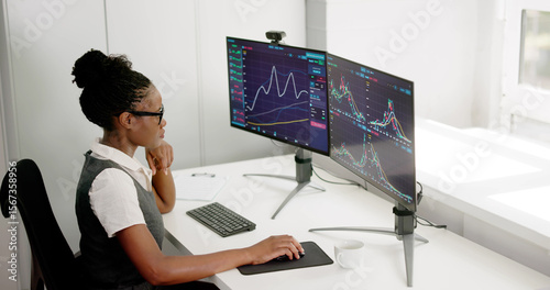 African Woman Broker Strategizing Online Trading