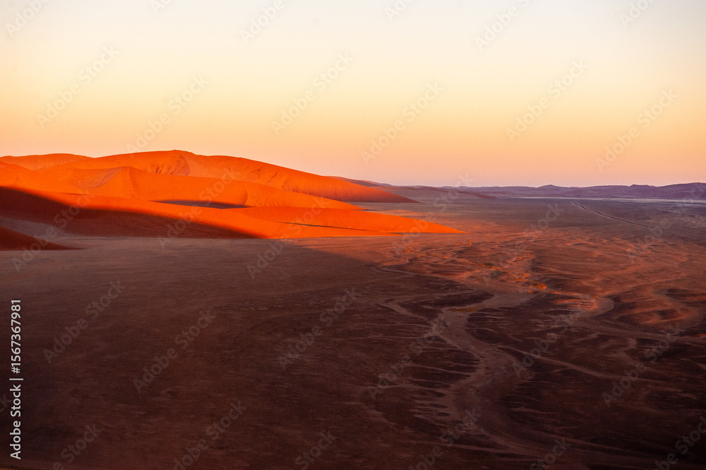 Fototapeta premium Exterior shot of the Namibian Sossusvlei sanddunes near the famous Dune 45 around sunrise