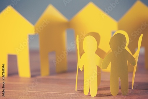 Paper people with houses on table