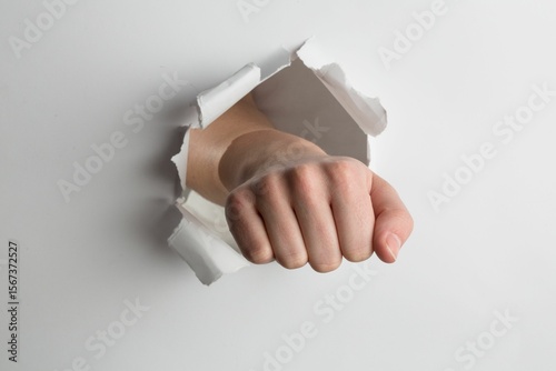 Fist punching through paper