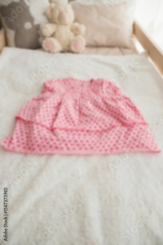 High angle view of stuffed toy by clothing on bed