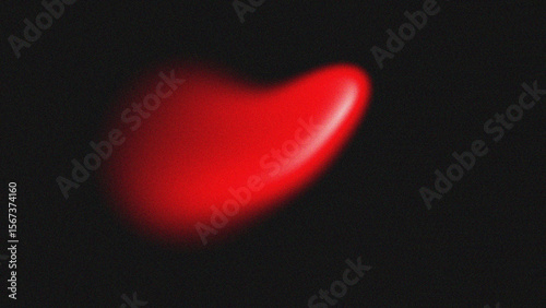 A vibrant, glossy, red heart shape glows against a dark, black background.