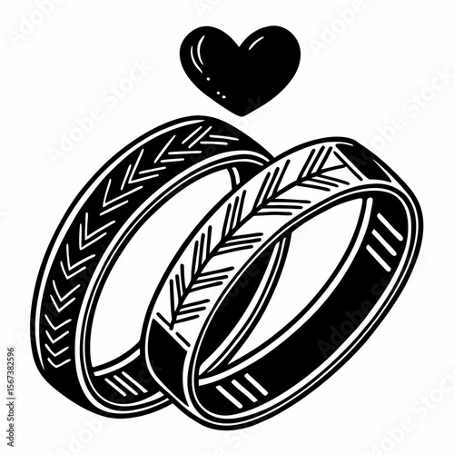 Two black and white wedding rings with a heart symbol above