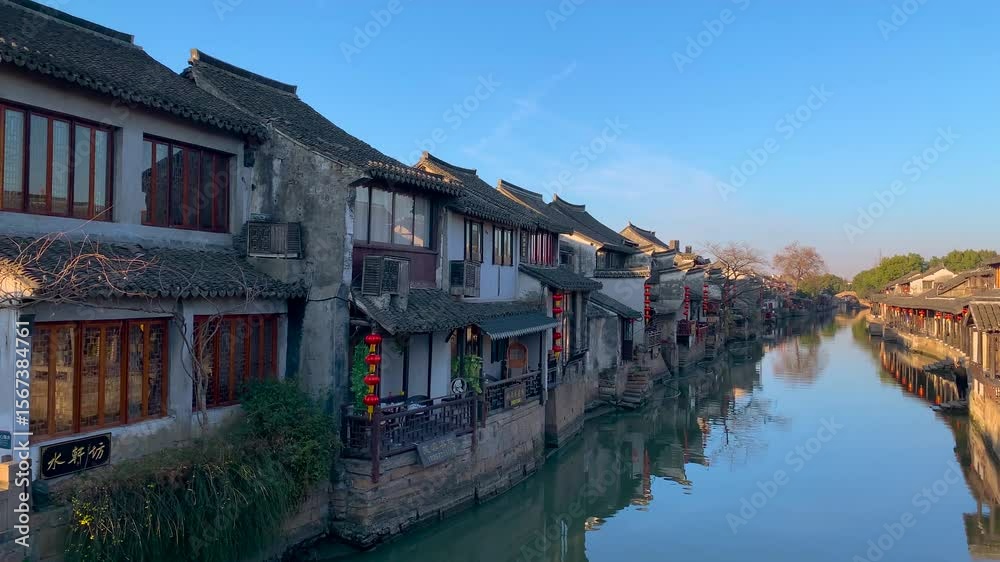 Exploring Xitang ancient town's charming bridges and serene waterways against a backdrop of historic architecture Exploring Xitang ancient town's charming bridges and serene waterways against a backdrop of historic architecture