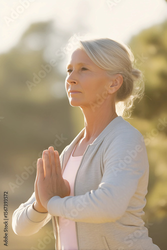 Elderly Woman in Meditation Pose with Sunset Light - Mental Health and Mindfulness