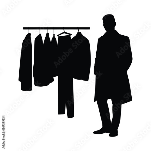 Silhouette of a man in a coat standing next to a rack of clothing