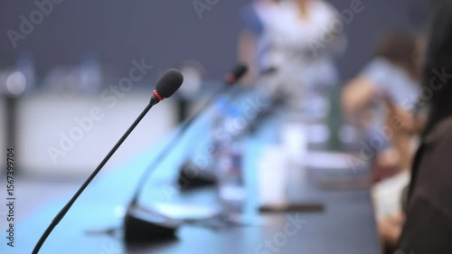 Wallpaper Mural Microphone is on a table in front of a group of people. The microphone is black and red Torontodigital.ca