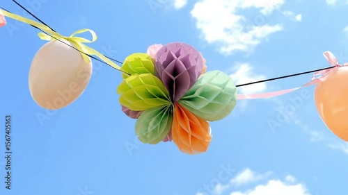 a rich deep teal and vintage pastel bunting decoration against a vibrant blue sky suggesting easter