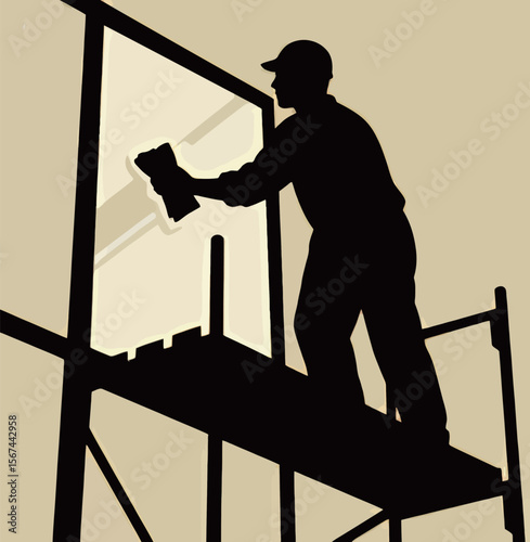 Silhouette of a construction worker cleaning a window on scaffolding