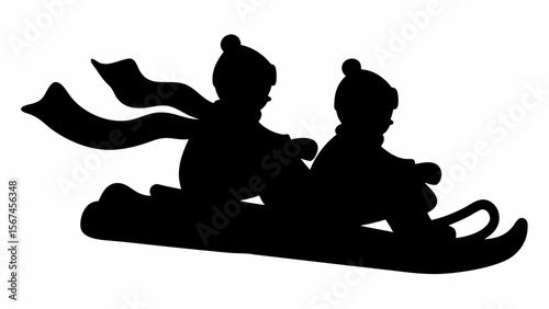 Silhouette of two children wearing hats and scarves sledding down a hill in a winter scene together having fun
