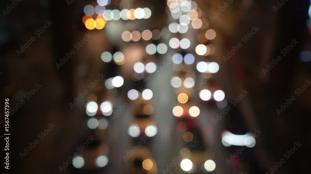 blurred out of focus view to street road full with traffic cars and buses transportation in night time in Chengdu city center, blurred traffic jam transportation