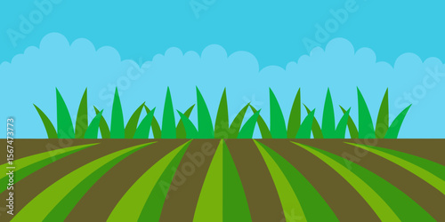 Bright green grass under a clear blue sky, evoking the essence of nature's vibrant summer landscape