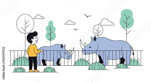 A young boy enthusiastically observes two majestic rhinos in an enclosure at the zoo