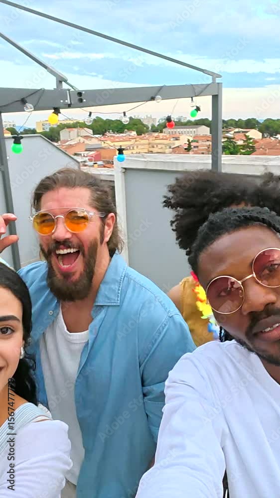 Friends taking a selfie on a rooftop at dusk