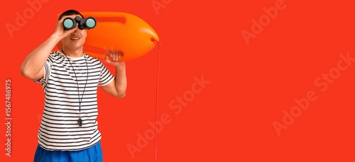 Male lifeguard with rescue ...
