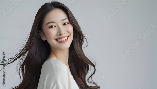 portrait of a beautiful Asian woman with long silky hair, fair smooth skin, and a joyful smile