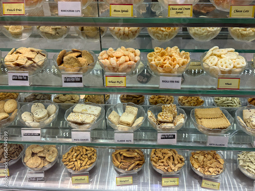 A display of various snacks and treats in a glass case