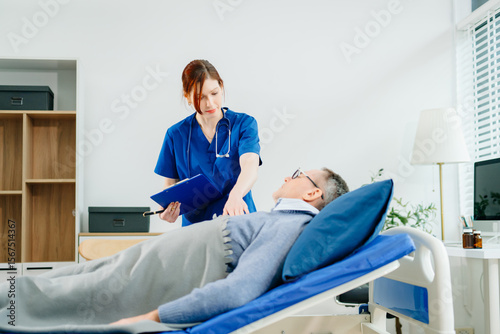 A nurse in blue scrubs conducts a bedside checkup for a senior patient in a bright room, highlighting real people,