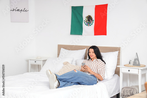 Young Mexican woman using m...