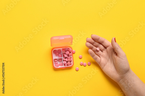 Female hand and container w...