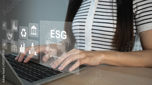 Woman analyze investment sustainability ESG icons. ESG environmental protection concept, sustainable development, climate change, green energy recycle, Net zero and carbon neutral.
