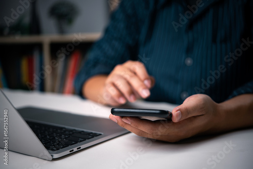 Papier peint Hands holding phone, interacting with laptop, online learning, mobile banking, digital lifestyle, home office